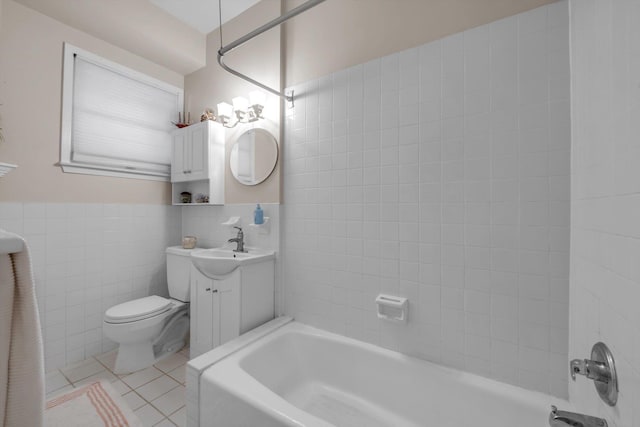 full bathroom with tile patterned floors, vanity, tub / shower combination, tile walls, and toilet