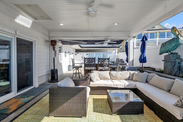 view of patio / terrace with fence, outdoor lounge area, a ceiling fan, and outdoor dining space