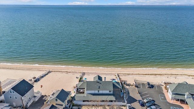 drone / aerial view featuring a view of the beach and a water view