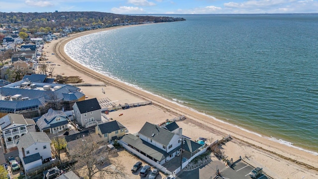 birds eye view of property featuring a beach view and a water view