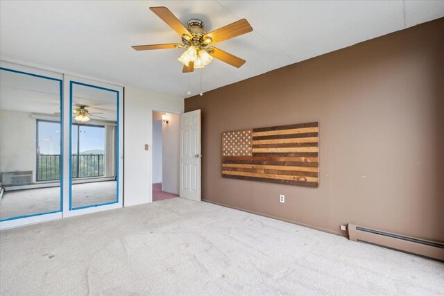 150 Overlook Ave Unit 8V, Peekskill, NY 10566 - unfurnished bedroom featuring carpet floors, access to exterior, a baseboard heating unit, and ceiling fan