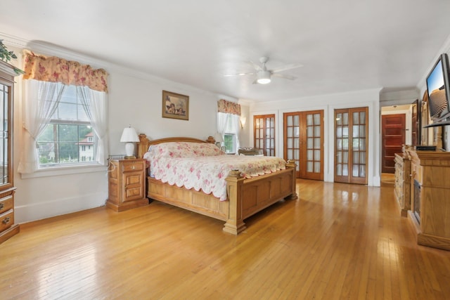 bedroom with baseboards, ornamental molding, french doors, and light wood finished floors