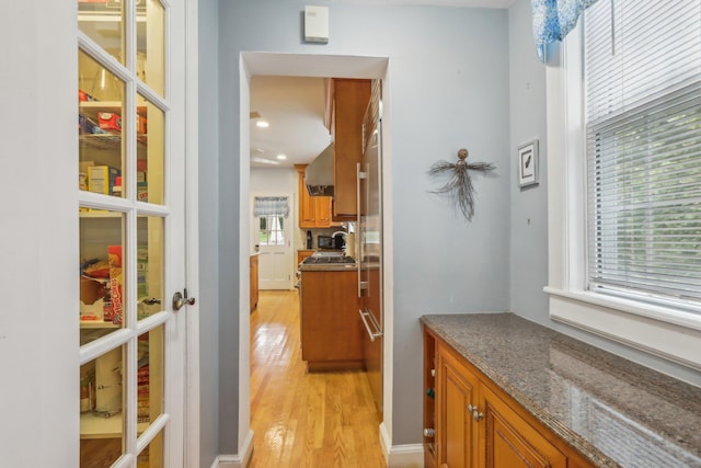 hallway with light wood-type flooring, recessed lighting, and french doors