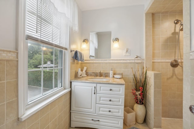 full bathroom featuring vanity, tile walls, and a tile shower