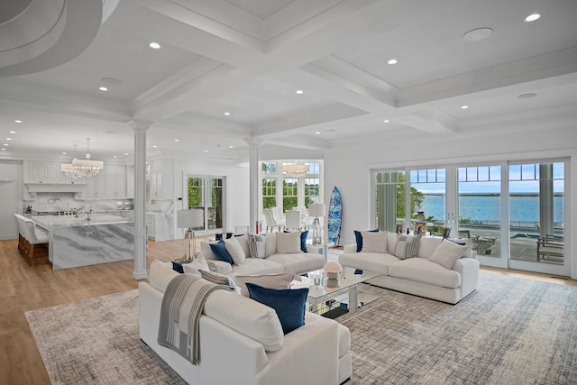 25 Brewster Ln, East Setauket, NY 11733 - living room with decorative columns, a chandelier, light wood finished floors, coffered ceiling, and beam ceiling