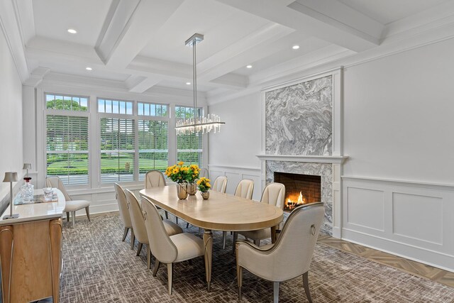 25 Brewster Ln, East Setauket, NY 11733 - dining room with coffered ceiling, beam ceiling, a decorative wall, and a high end fireplace