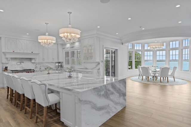 25 Brewster Ln, East Setauket, NY 11733 - kitchen featuring a chandelier, healthy amount of natural light, white cabinets, recessed lighting, and tasteful backsplash