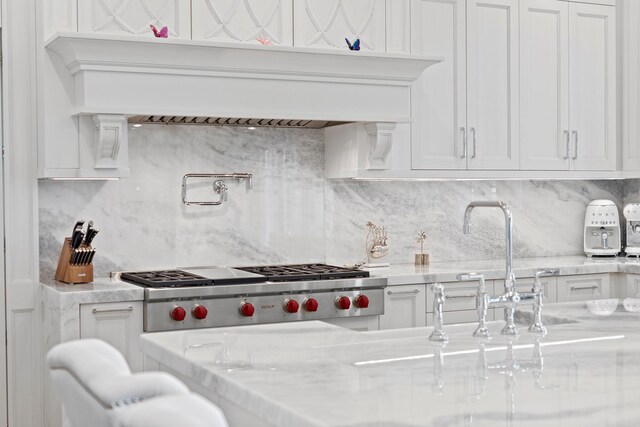 25 Brewster Ln, East Setauket, NY 11733 - kitchen featuring white cabinets, backsplash, light stone countertops, and a sink