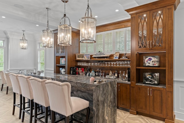 25 Brewster Ln, East Setauket, NY 11733 - indoor bar with a chandelier, a decorative wall, pendant lighting, wainscoting, and recessed lighting