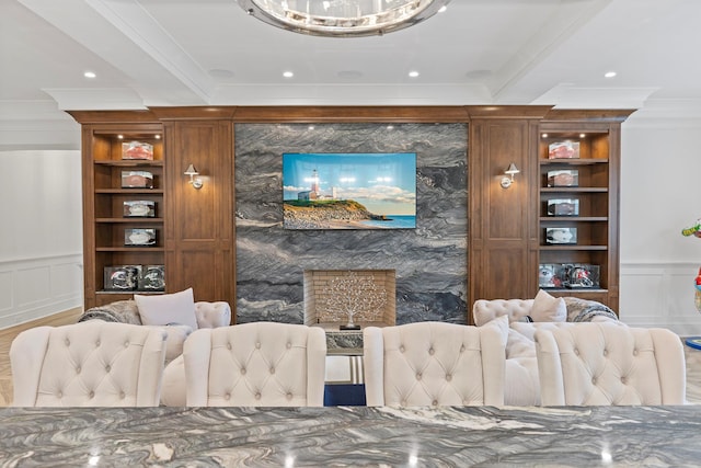 25 Brewster Ln, East Setauket, NY 11733 - living room with ornamental molding, a decorative wall, and wood finished floors