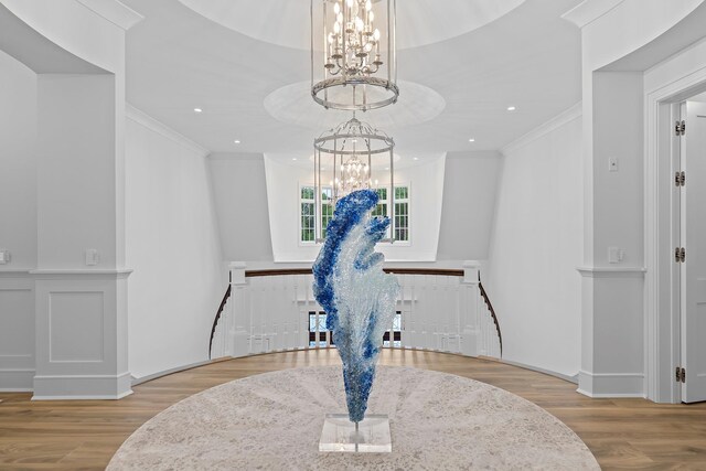 25 Brewster Ln, East Setauket, NY 11733 - detailed view of a chandelier, ornamental molding, and wood finished floors
