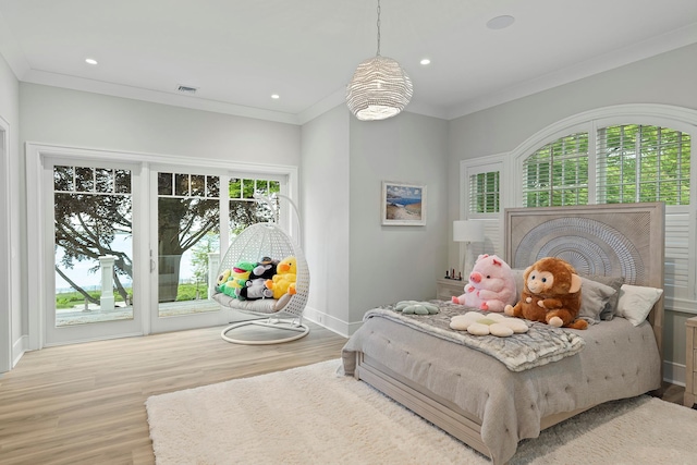 25 Brewster Ln, East Setauket, NY 11733 - bedroom with multiple windows, wood finished floors, baseboards, access to exterior, and crown molding
