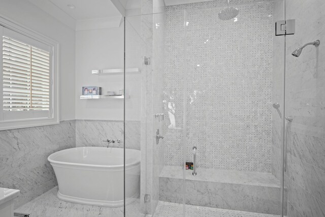 25 Brewster Ln, East Setauket, NY 11733 - bathroom featuring a shower stall, a freestanding bath, tile walls, and a wainscoted wall