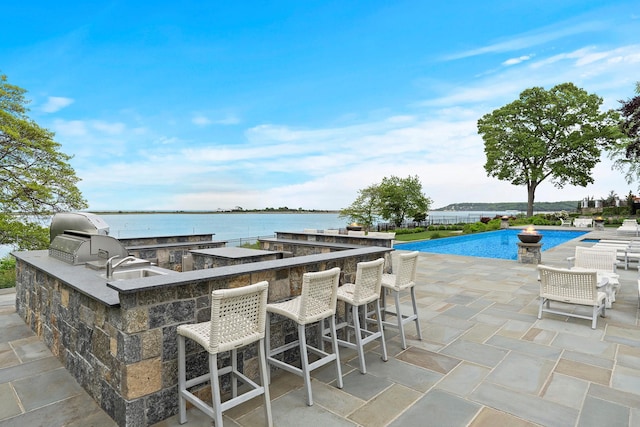 25 Brewster Ln, East Setauket, NY 11733 - view of patio featuring an outdoor pool and a water view