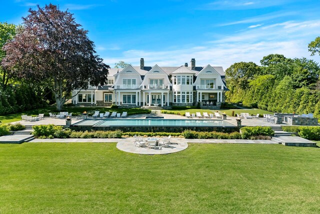 25 Brewster Ln, East Setauket, NY 11733 - back of property featuring a balcony, a patio, a yard, and a pool