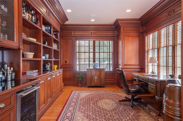 office space with recessed lighting, ornamental molding, beverage cooler, and light wood-style flooring