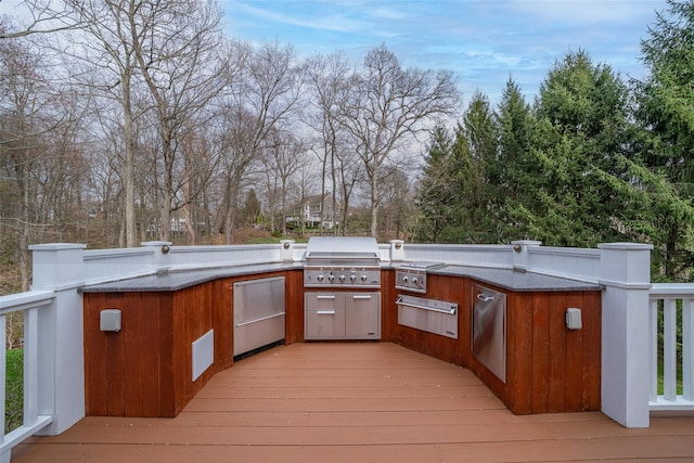 wooden terrace with an outdoor kitchen and a grill