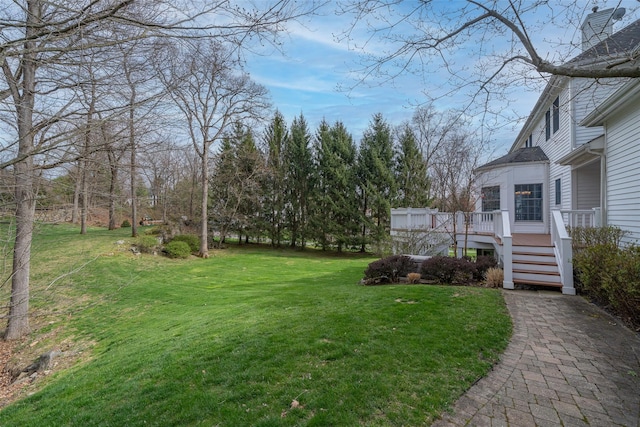 view of yard with stairway and a deck