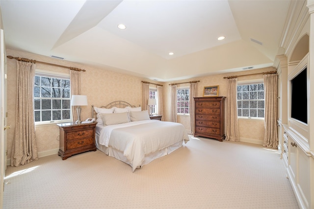 bedroom with visible vents, carpet, and multiple windows