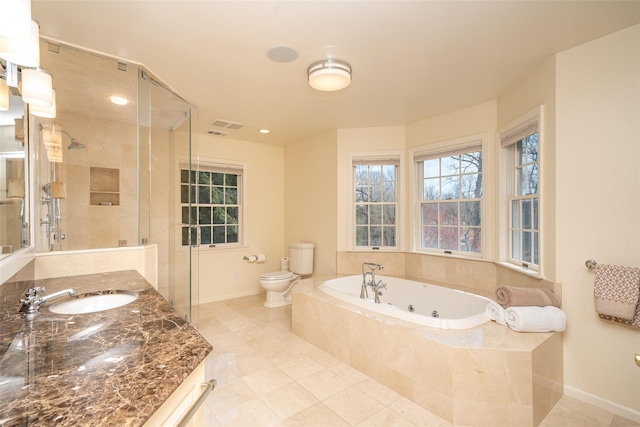 bathroom with a shower stall, toilet, a jetted tub, baseboards, and tile patterned flooring