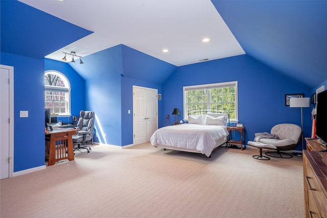 bedroom with vaulted ceiling, baseboards, visible vents, carpet, and a closet