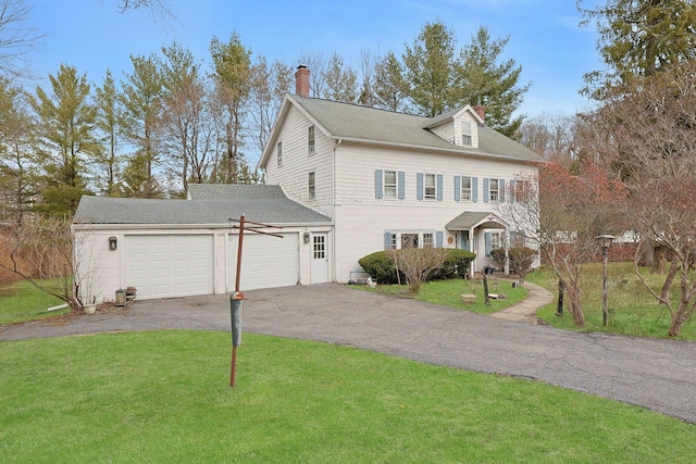 view of front of property with aphalt driveway, roof with shingles, a front lawn, an attached garage, and a chimney