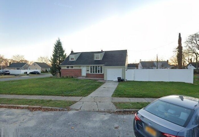 cape cod-style house featuring a front lawn, fence, an attached garage, and concrete driveway