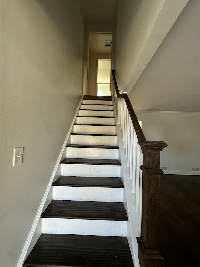 stairs with baseboards and wood finished floors