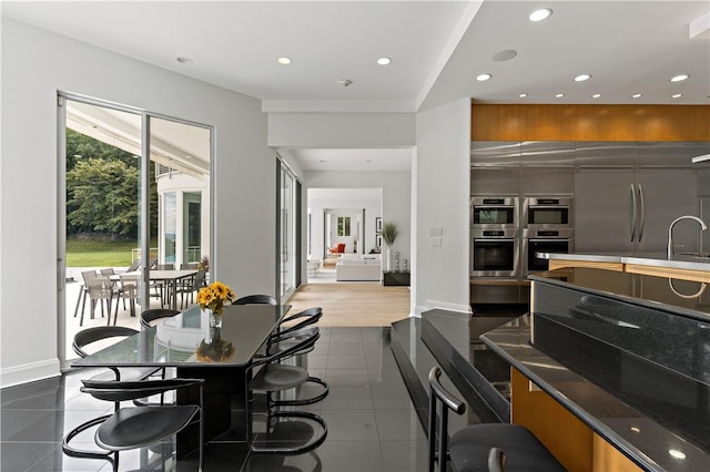 interior space with recessed lighting, stainless steel appliances, and modern cabinets