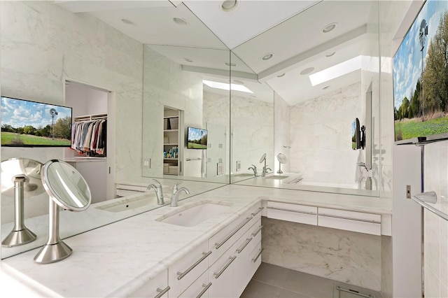 full bath with a walk in closet, tile patterned flooring, vanity, and recessed lighting