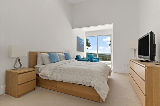bedroom featuring baseboards and light colored carpet