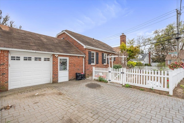 232 Courthouse Rd, Franklin Square, NY 11010 - view of side of property with fence, an attached garage, a gate, and brick siding