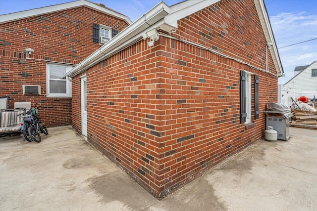 232 Courthouse Rd, Franklin Square, NY 11010 - view of side of property featuring a patio area and brick siding