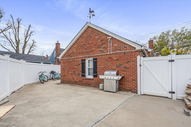 232 Courthouse Rd, Franklin Square, NY 11010 - exterior space with a gate, a patio, brick siding, and a fenced backyard