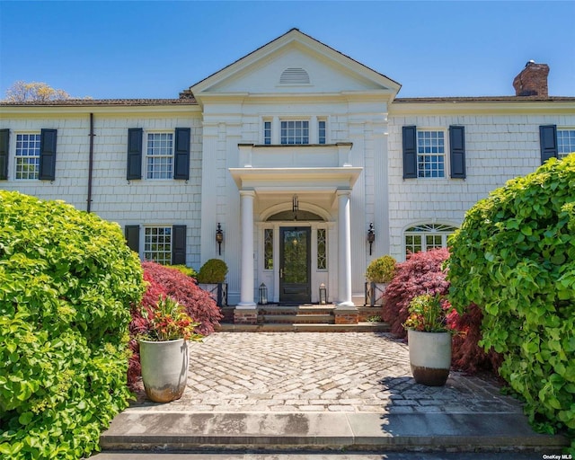 entrance to property featuring a chimney