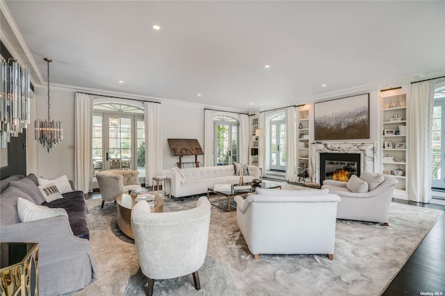 living room with a high end fireplace, ornamental molding, wood finished floors, and recessed lighting