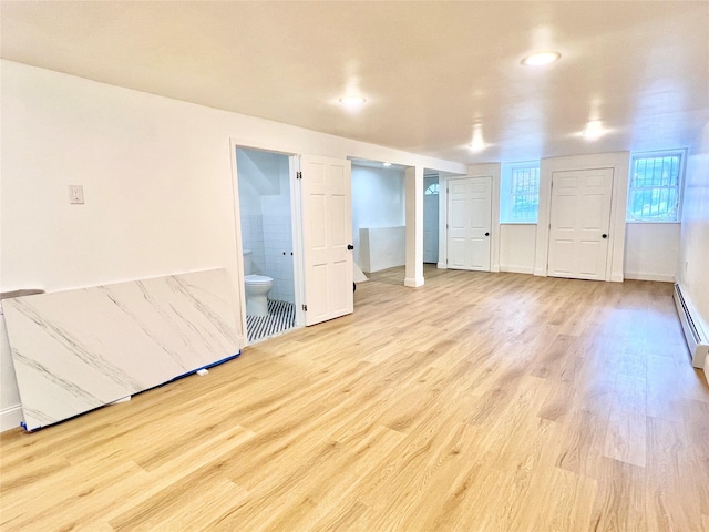 unfurnished bedroom with light wood-type flooring, baseboards, connected bathroom, and recessed lighting