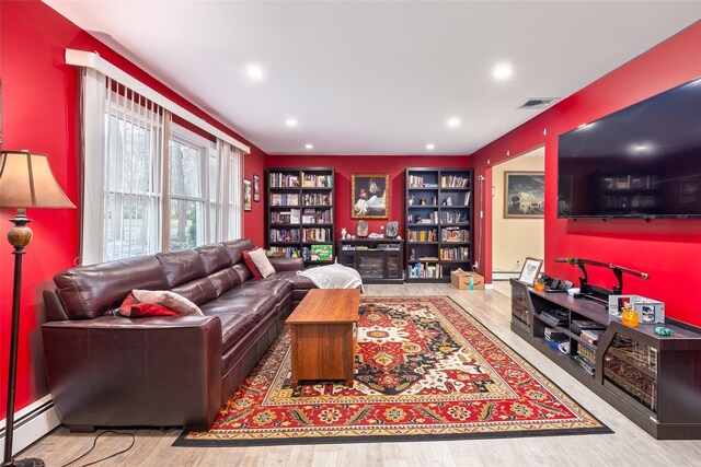 living room featuring visible vents, recessed lighting, built in features, baseboard heating, and wood finished floors