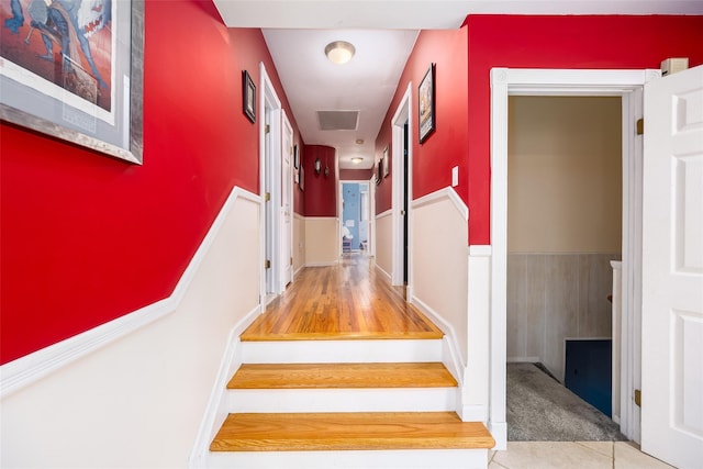 staircase with visible vents and carpet floors