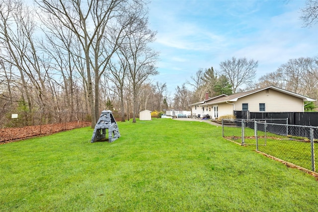 view of yard featuring fence and a shed