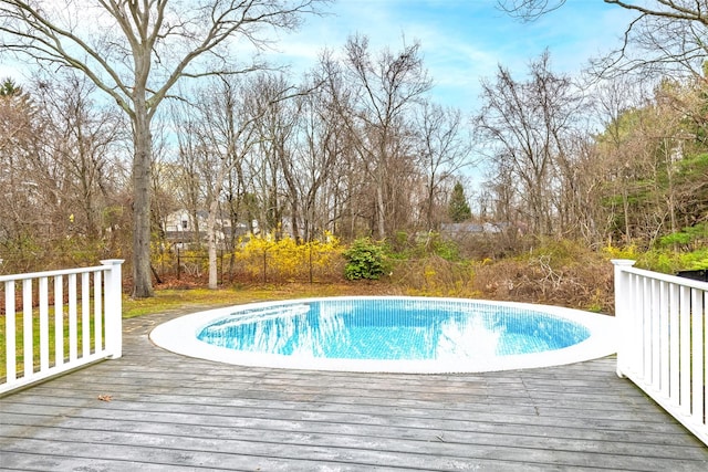 outdoor pool with a wooden deck