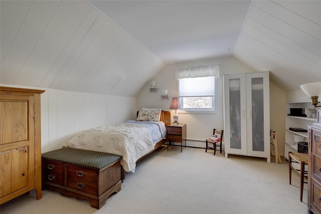 bedroom with lofted ceiling, light carpet, and a baseboard heating unit