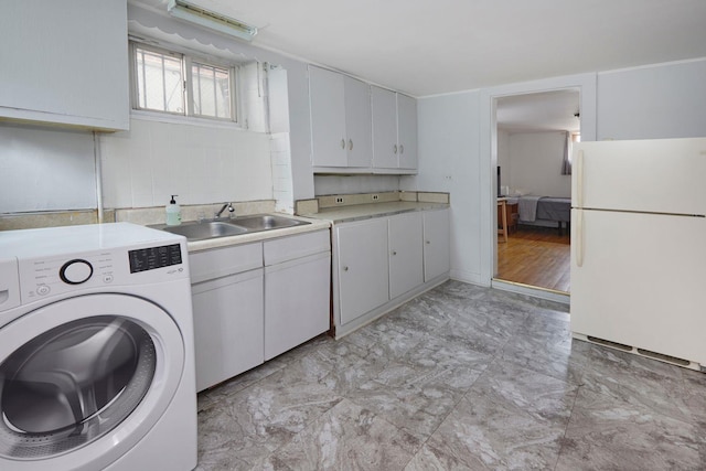 washroom with washer / dryer, marble finish floor, and a sink