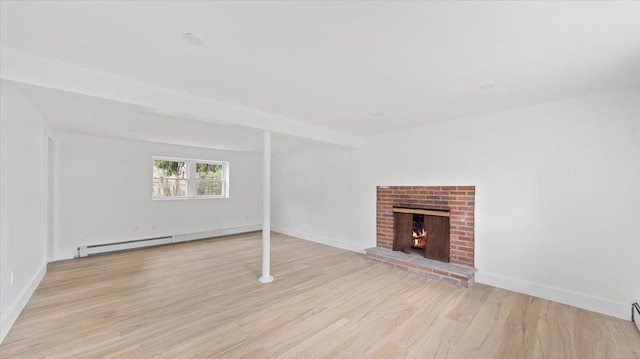 unfurnished living room with a baseboard heating unit, baseboards, wood finished floors, and a fireplace