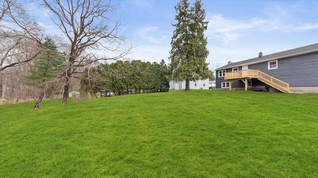 view of yard with a wooden deck and stairs
