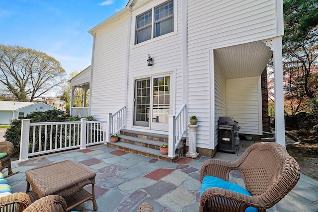 back of property featuring entry steps and a patio area