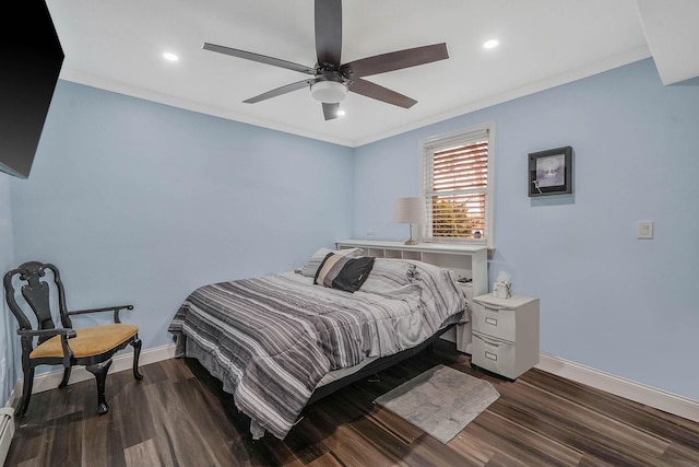 bedroom featuring baseboards, dark wood-style floors, and crown molding