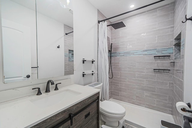 bathroom featuring toilet, vanity, recessed lighting, and tiled shower