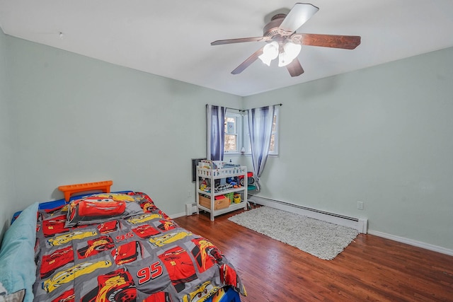 bedroom featuring baseboards, wood finished floors, a baseboard radiator, and ceiling fan