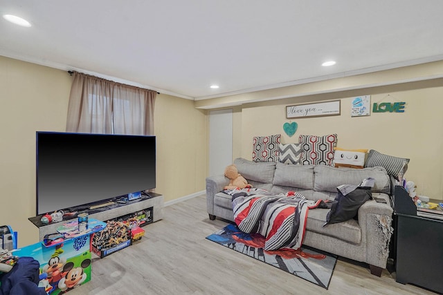 living area with recessed lighting, wood finished floors, crown molding, and baseboards